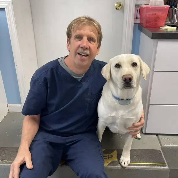 Dr. Scott Falls with a yellow Labrador